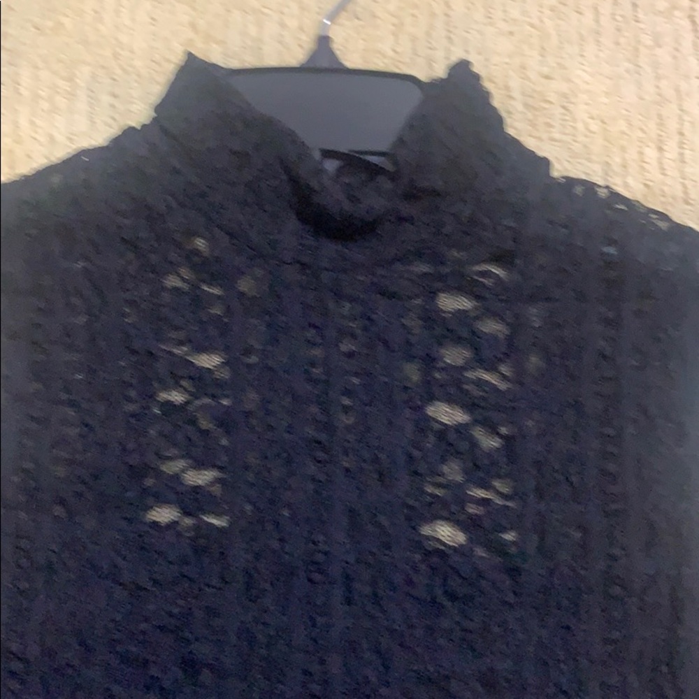 Black lace lined sleeveless high neck top.